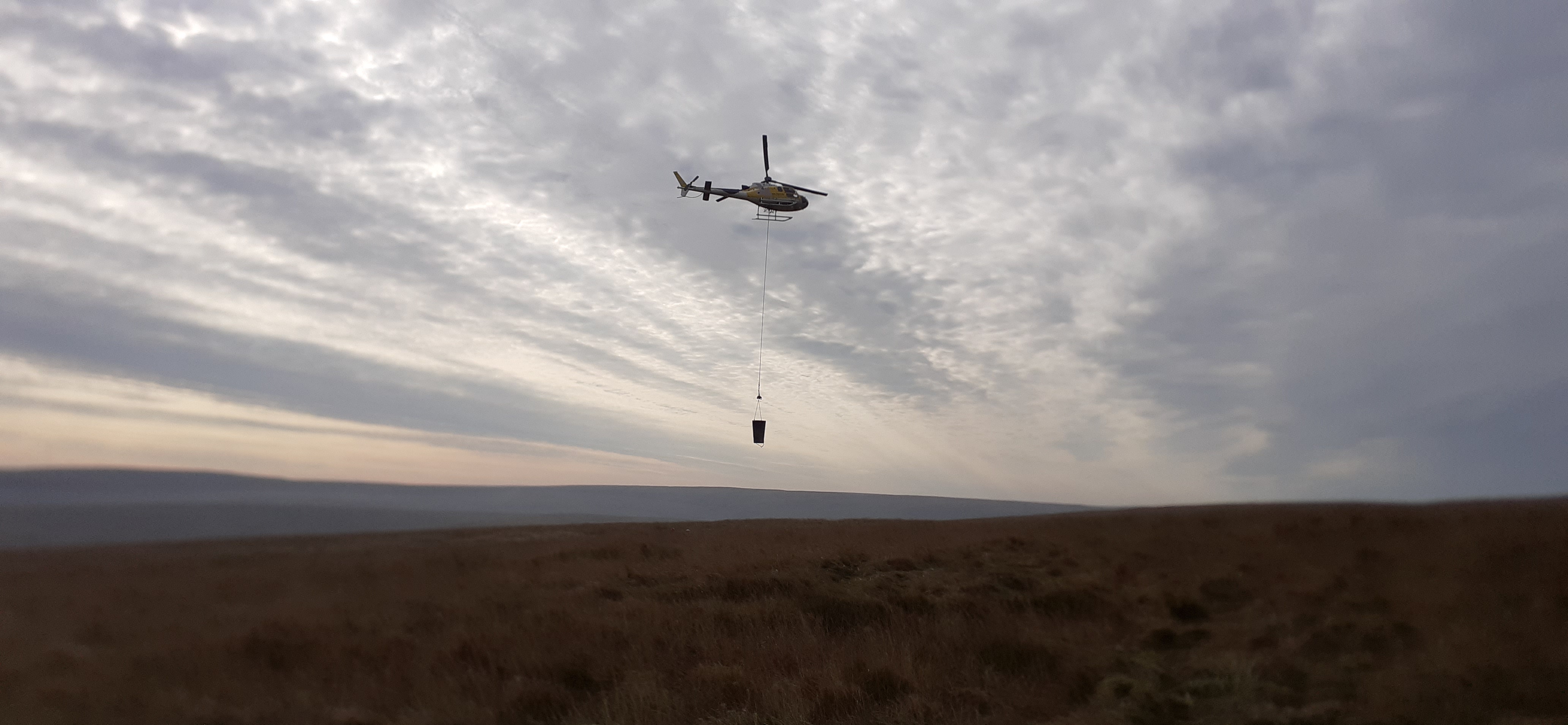 Helicopter flying materials at Close Moss