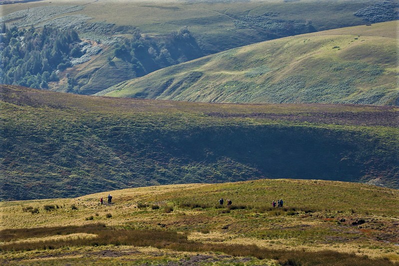 People walking in vast landscape