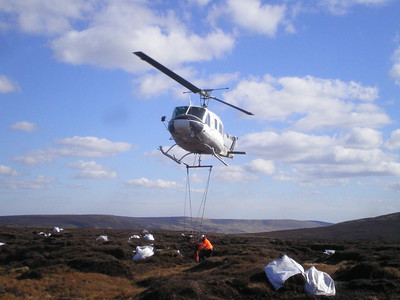 Helicopter and bags of heather brash