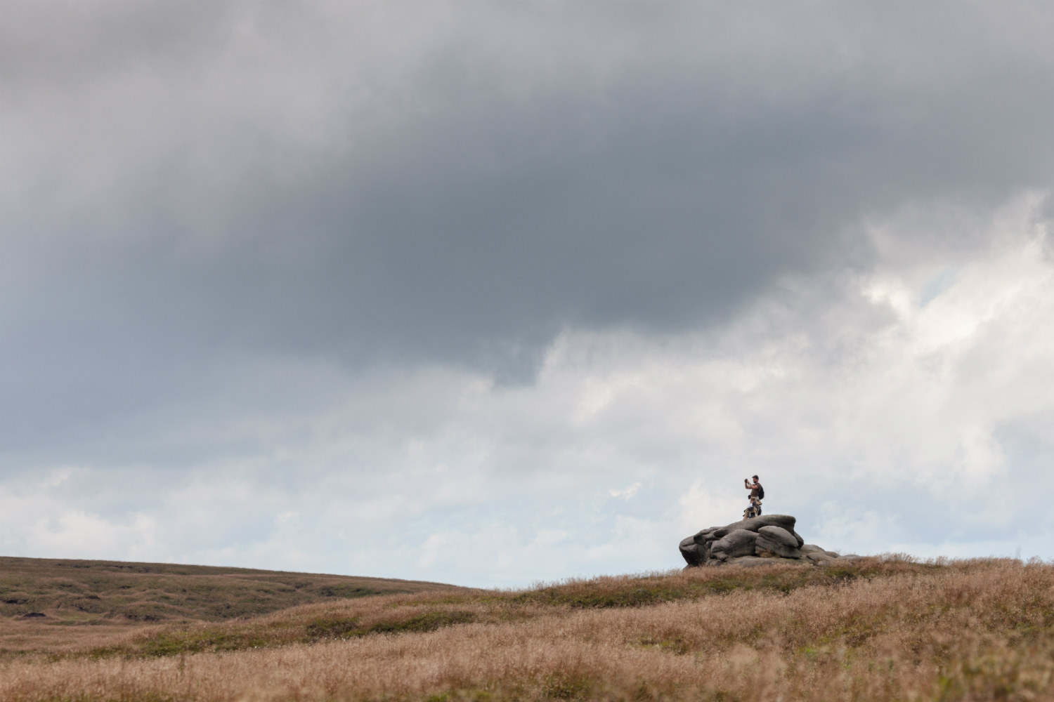 Walker stood atop a large rock at Bleaklow