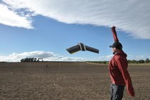 Picture of the unmanned aerial vehicle taking flight over a field